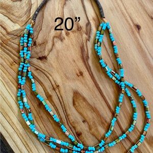 3 strand necklace of glass beads and turquoise seed beads with flossed accent